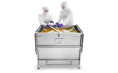 Mobius® 3D single-use assemblies Two technicians in a sterile environment are operating a Mobius 2D and 3D single-use assembly system. They are dressed in full protective cleanroom suits, complete with hoods and masks, ensuring a contamination-free process.