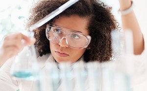 Woman Scientist Woman in lab working with test tube and beaker